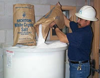 Utility Tech Adding Salt to Brine Tank